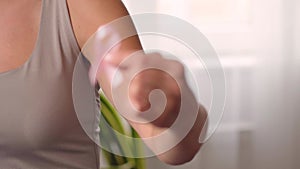 Woman hold pink ribbon. Close up view of hand with symbol of national breast canser awareness month in october