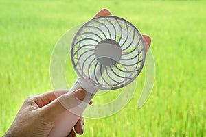 Woman hold portable motor USB fan for outdoors travel