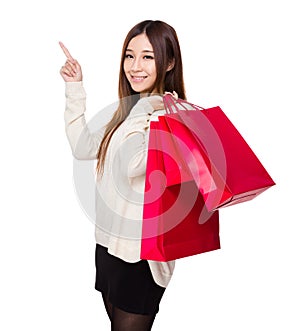 Woman hold with red shopping bag and finger point up