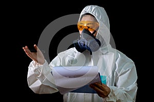 Woman hold report file folder in white chemical protective clothing and antigas mask with yellow glasses at white background photo