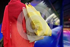 Woman hold shopping bags and smiling on city street. Christmas shopping, winter sale concept