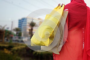 Woman hold shopping bags and smiling on city street. Christmas shopping, winter sale concept