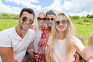 Woman hold smart phone camera taking selfie photo friends face close up picnic countryside