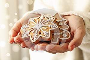 Woman hold tasty Christmas cookie, close up