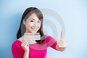 Woman hold teeth whitening tool photo