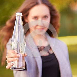 Woman hold water bottle. Glass