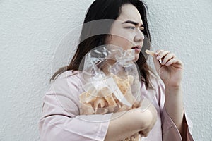 A woman hold the whole of rice cracker