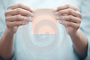 Woman holding adhesive note