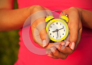 Woman Holding Alarm Clock