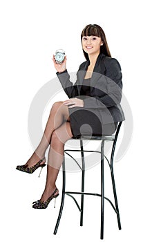 Woman holding alarm sitting on chair