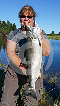 Woman Holding Alaska Silver Salmon photo