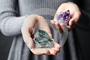 Woman holding amethyst and labradorite gemstones