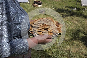 Woman is holding apetite national pies in hands photo