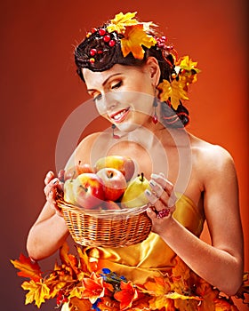 Woman holding autumn basket.