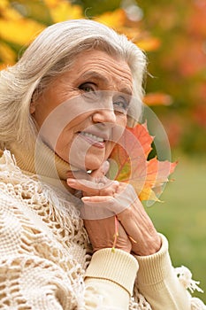 Woman holding autumn leaves