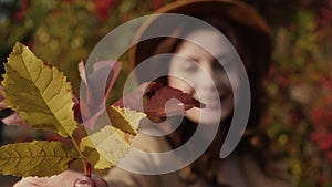 Woman holding autumn leaves