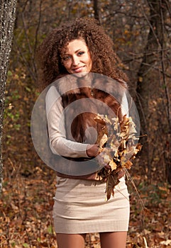 Woman holding autumn leaves