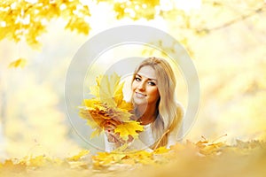 Woman holding autumn leaves