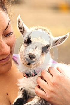 Woman Holding Baby Goat