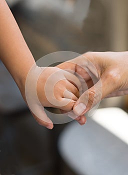 Woman holding baby in hand