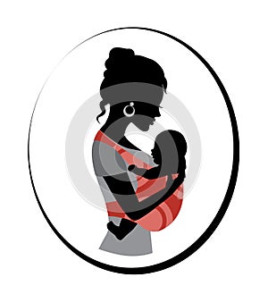 Woman is holding a baby in a sling