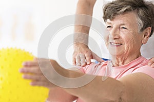 Woman holding ball in physiotherapy