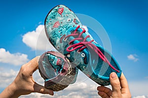 Woman is holding barefoot shoes with flexible sole