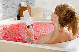 Woman holding bathing product in hand