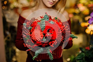 Woman holding a beautiful bouquet of red flowers for the Valentine day