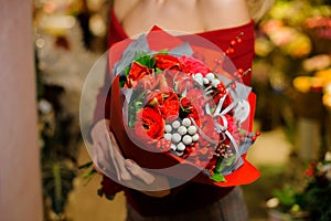 Woman holding a beautiful bouquet of red and white flowers for the Valentine day