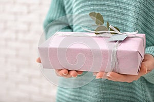 Woman holding beautiful gift box, closeup