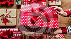 Woman holding beautifully wrapped vintage christmas present, hands detail. Xmas web banner