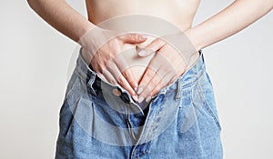 woman holding belly with abdominal or period pains