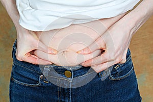 Woman holding belly fat