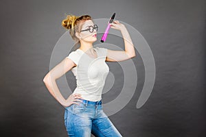 Woman holding big oversized pencil thinking about something