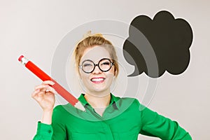 Woman holding big oversized pencil thinking