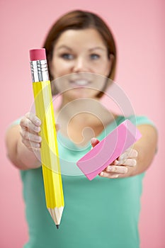 Woman Holding Big Pencil And Eraser