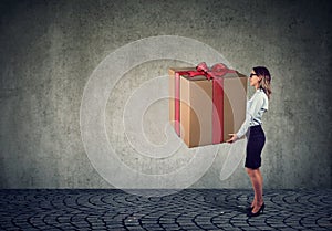 Woman holding a big present gift box