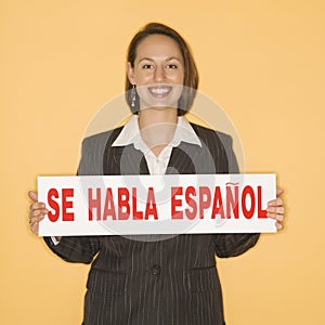 Woman holding bilingual sign photo