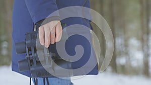 Woman holding binoculars in her hands