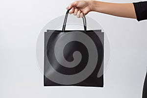 Woman holding black canvas bag with copy space on grey background