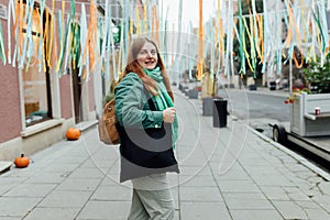 Woman holding black canvas tote bag. Mockup and zero waste concept. Eco Nature Friendly Style. Environmental