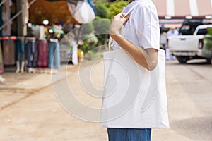 woman holding black cotton bag in nature background