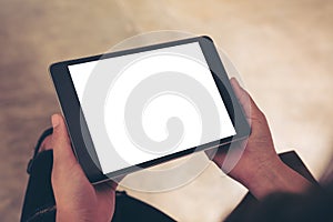 Woman holding black tablet pc with blank white desktop screen