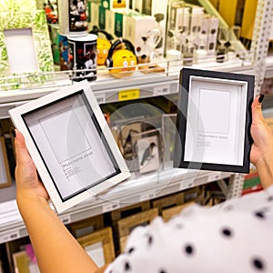 Woman holding black and white photo frames