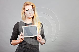 Woman holding blank black board