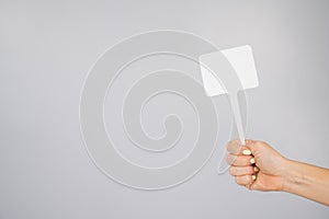 Woman holding blank sign on white background. Copy space.