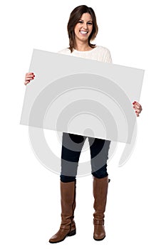 Woman holding a blank white sign