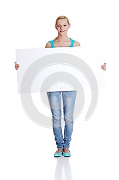 Woman is holding blank whiteboard sign