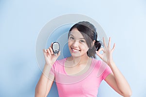 Woman holding blood glucose meter